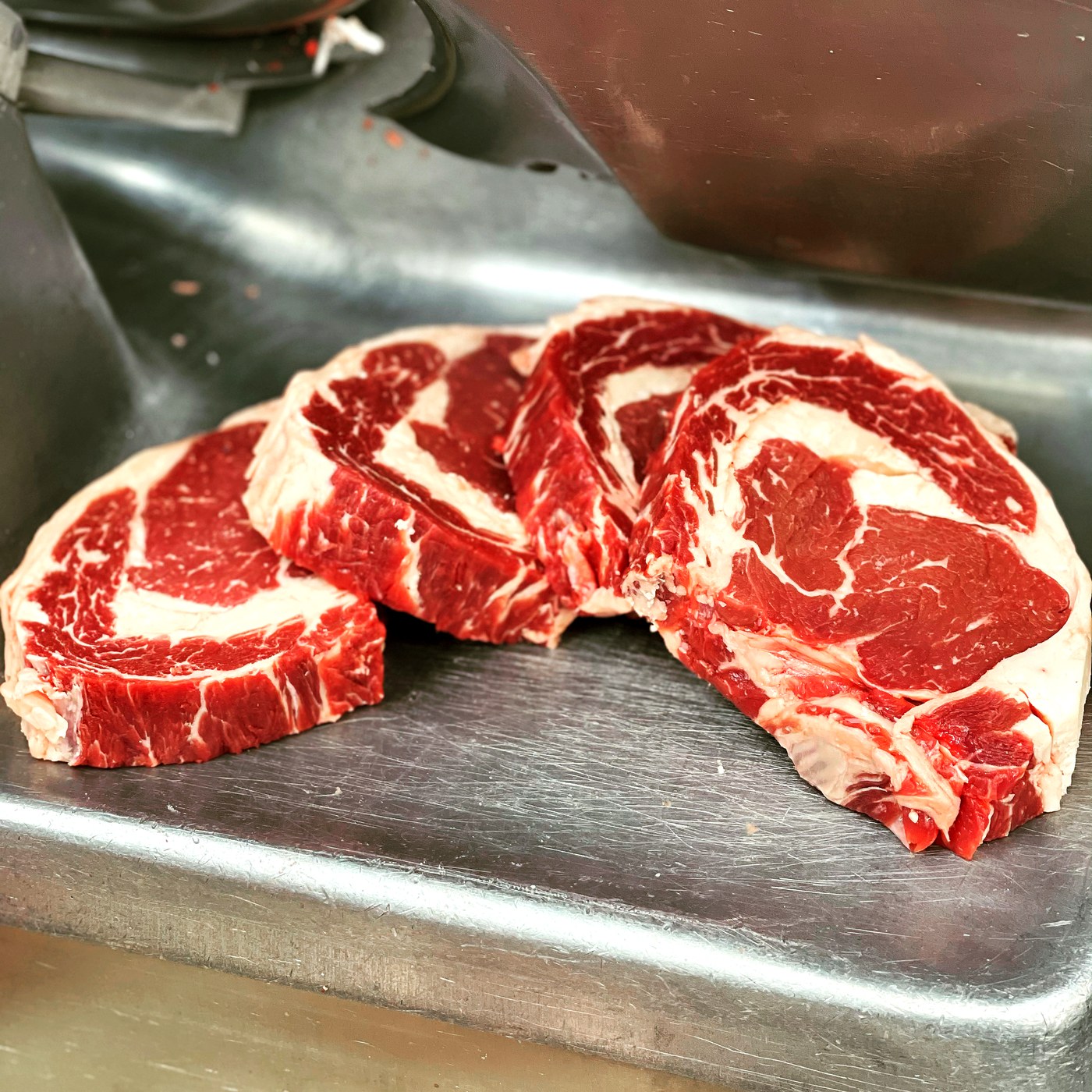 Fresh ribeye steaks cut in house